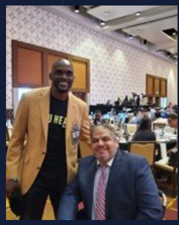 Gabey Abikzer with a guest at a speaking event