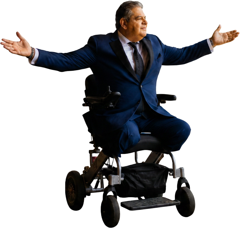 Gabey S. Abikzer in a navy suit with arms open wide